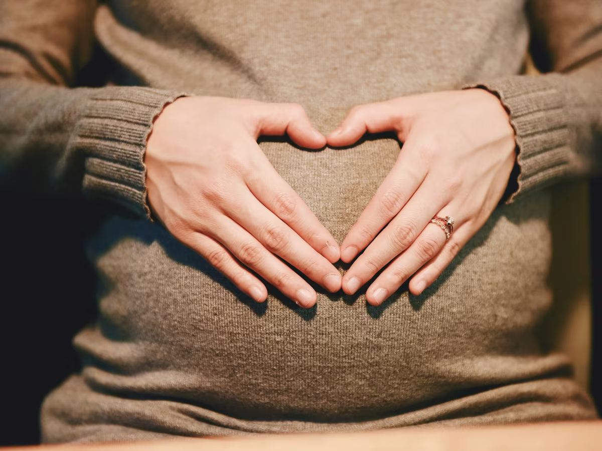 The image features two hands reaching towards each other against a plain background. 